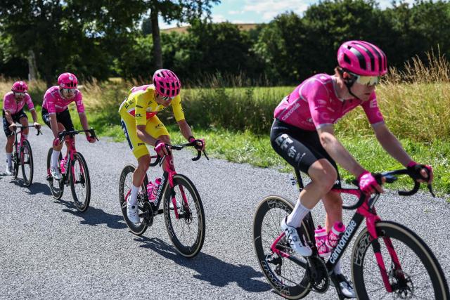 EF Education - EasyPost's French rider Alex Baudin wearing the overall leader's yellow jersey cycles with teammates including EF Education - EasyPost's German rider Georg Steinhauser (R) during the 5th stage of the Tour Auvergne-Rhone-Alpes cycling race (formerly known as the Criterium du Dauphine), 195,8km between Saint-Chamond and Villars-les-Dombes, central France, on June 11, 2026. (Photo by Anne-Christine POUJOULAT / AFP)