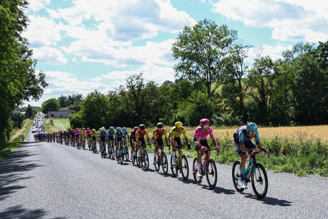 The pack of riders cycles during the 5th stage of the Tour Auvergne-Rhone-Alpes cycling race (formerly known as the Criterium du Dauphine), 195,8km between Saint-Chamond and Villars-les-Dombes, central France, on June 11, 2026. (Photo by Anne-Christine POUJOULAT / AFP)