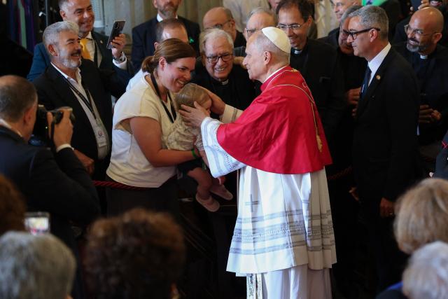Pope Leo XIV blesses a baby during a meeting with bishops, priests, deacons, religious, seminarians and pastoral workers in the cathedral of Saint Anne in Las Palmas on the Canary Island of Gran Canaria, a place accustomed to the arrival of migrants, on June 11, 2026. Pope Leo XIV is visiting Spain June 6-12 with stops in Madrid, Barcelona, and the Canary Islands, where he will meet with migrants and organisations dedicated to helping them. (Photo by Jaime REINA / AFP)