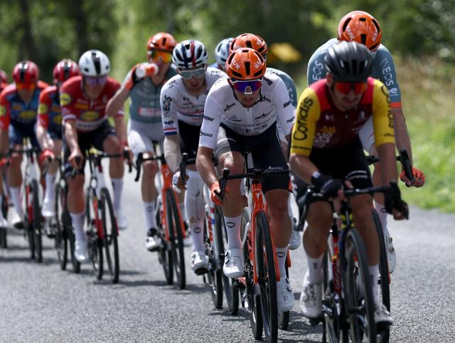 Netcompany Ineos Cycling Team's French rider Kévin Vauquelin (C) wearing the best young rider's white jersey cycles during the 5th stage of the Tour Auvergne-Rhone-Alpes cycling race (formerly known as the Criterium du Dauphine), 195,8km between Saint-Chamond and Villars-les-Dombes, central France, on June 11, 2026. (Photo by Anne-Christine POUJOULAT / AFP)