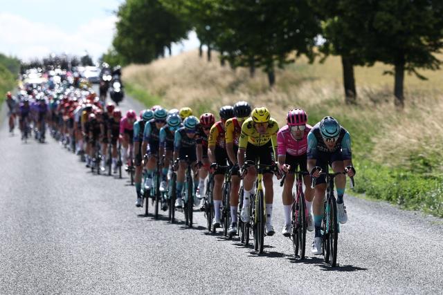 The pack of riders cycles during the 5th stage of the Tour Auvergne-Rhone-Alpes cycling race (formerly known as the Criterium du Dauphine), 195,8km between Saint-Chamond and Villars-les-Dombes, central France, on June 11, 2026. (Photo by Anne-Christine POUJOULAT / AFP)