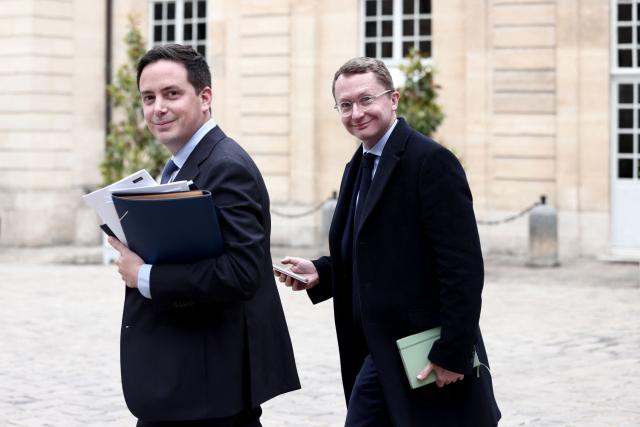 French far-right party Rassemblement National (RN) MP Yoann Gillet (L) and liberal party Renaissance MP Paul Midy (R) leave after attending a meeting with France's Prime Minister gathering several political parties and security institutions representatives on safeguarding democratic debates against foreign interference after Paris prosecutors opened in May a probe to investigate whether an Israeli company interfered in local French elections, at the Matignon Hotel in Paris on June 11, 2026. The case was opened after several far-left candidates charged they were targeted by disinformation campaigns, as France's government body responsible for combatting online disinformation Viginum said that it had noted a "system of artificial or automated dissemination to spread manifestly inaccurate or misleading content". (Photo by Behrouz MEHRI / AFP)