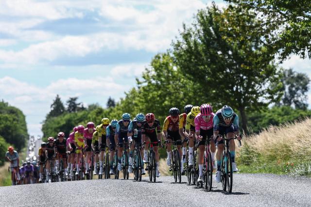 The pack of riders cycles during the 5th stage of the Tour Auvergne-Rhone-Alpes cycling race (formerly known as the Criterium du Dauphine), 195,8km between Saint-Chamond and Villars-les-Dombes, central France, on June 11, 2026. (Photo by Anne-Christine POUJOULAT / AFP)