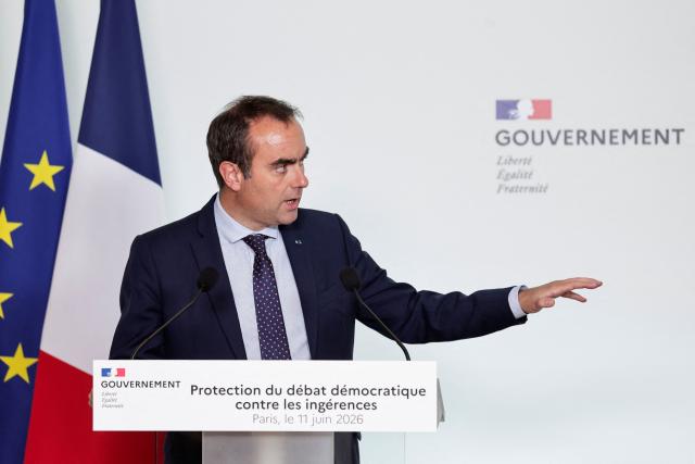 France's Prime Minister Sebastien Lecornu gestures as he speaks during a press conference following a meeting with several political parties and security institutions representatives on safeguarding democratic debates against foreign interference after Paris prosecutors opened in May a probe to investigate whether an Israeli company interfered in local French elections, at the Matignon Hotel in Paris on June 11, 2026. The case was opened after several far-left candidates charged they were targeted by disinformation campaigns, as France's government body responsible for combatting online disinformation Viginum said that it had noted a "system of artificial or automated dissemination to spread manifestly inaccurate or misleading content". (Photo by STEPHANE DE SAKUTIN / AFP)