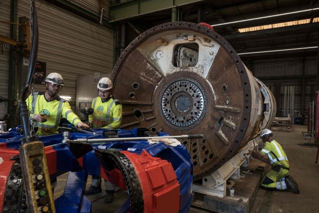 Engineers work on a tunnel-digging machine during a media tour of BESSAC, a company specializing in the construction of tunnels and micro-tunnels, at their plant in Saint-Jory, near Toulouse, southwestern France on June 11, 2026. (Photo by Ed JONES / AFP)