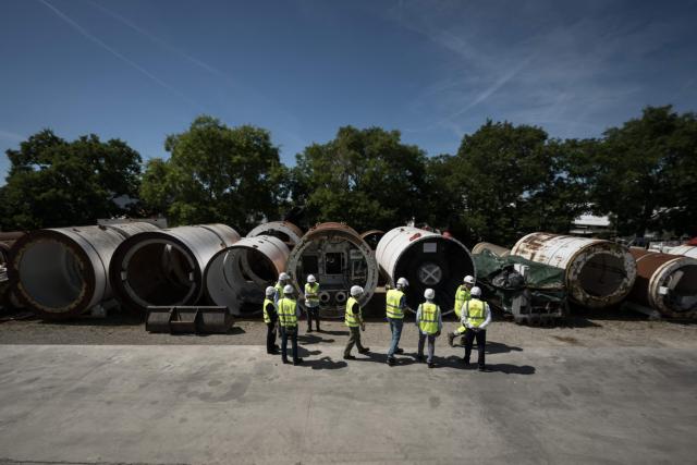 Journalists look at tunnelling machines during a media tour of BESSAC, a company specializing in the construction of tunnels and micro-tunnels, at their plant in Saint-Jory, near Toulouse, southwestern France on June 11, 2026. (Photo by Ed JONES / AFP)