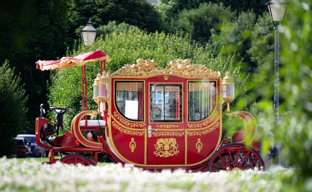 A photograph taken on June 11, 2026 shows an electric powered tourist sightseeing vehicle, made in retro imperial carriage style, parked outside the Hofburg palace in Vienna. (Photo by Joe Klamar / AFP)