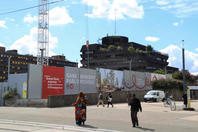 Pedestrians walk past the construction site of the future metro station in the city center of Bobigny, north-eastern suburb of Paris on June 11, 2026. (Photo by Ludovic MARIN / AFP)