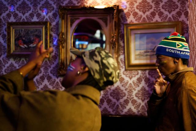 South African football supporters react and cheer during the national anthem as they watch the live broadcast of the opening football match of the 2026 FIFA World Cup between Mexico and South Africa, at Kitcheners in Braamfontein, in Johannesburg, on June 11, 2026. (Photo by WIKUS DE WET / AFP)