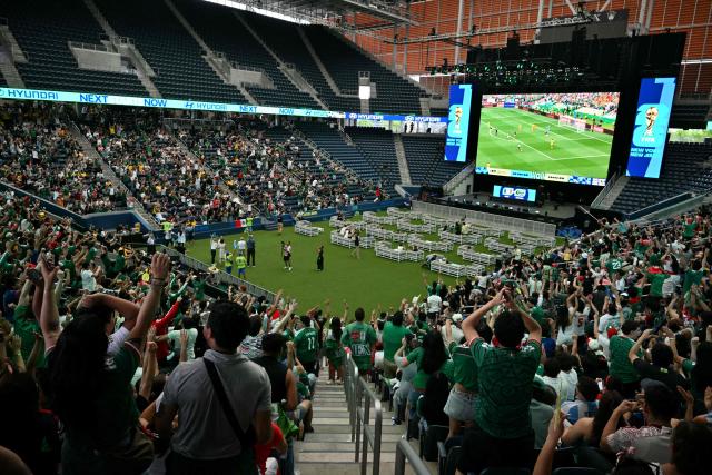 Fans celebrate Mexico's first goal in the opening match of the 2026 World Cup football tournament during a watch party at the "Queens Group Stage HQ" at USTA Billie Jean King National Tennis Center in New York, on June 11, 2026. (Photo by ANGELA WEISS / AFP)