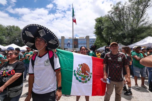 Mexico supporter hold the national flag as they watch the opening match of the 2026 World Cup, a Group A match between Mexico and South Africa played in Mexico City, in Monterrey, Nuevo Leon, on June 11, 2026. (Photo by Julio Cesar AGUILAR / AFP)