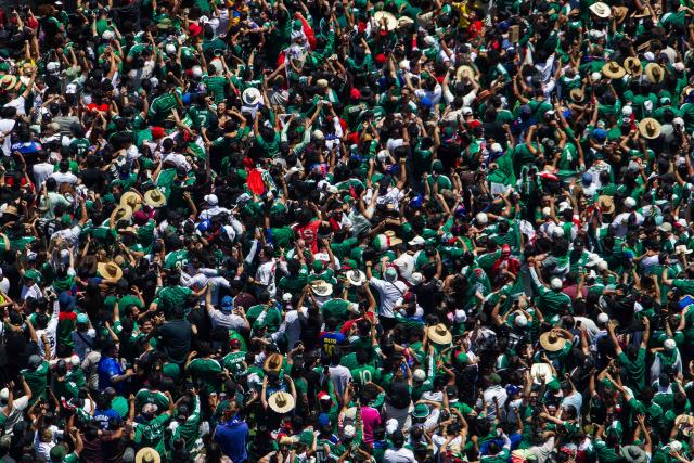 Mexico fans celebrate a goal scored by Julian Quinones as they watch the match between Mexico and South Africa during the FIFA Fan Festival at the LA Memorial Coliseum on opening day of the 2026 World Cup football tournament at in Los Angeles on June 11, 2026. Mexico and South Africa are opening the 2026 World Cup football tournament Group A, in Mexico City. (Photo by Apu GOMES / AFP)