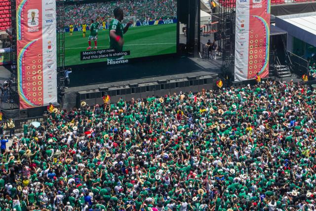 Mexico fans celebrate a goal scored by Julian Quinones as they watch the match between Mexico and South Africa during the FIFA Fan Festival at the LA Memorial Coliseum on opening day of the 2026 World Cup football tournament at in Los Angeles on June 11, 2026. Mexico and South Africa are opening the 2026 World Cup football tournament Group A, in Mexico City. (Photo by Apu GOMES / AFP)