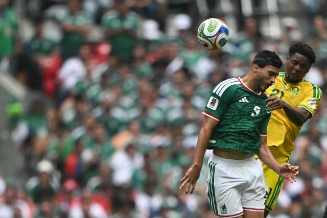 Mexico's forward #09 Raul Jimenez and South Africa's defender #21 Ime Okon fight for the ball during the 2026 World Cup Group A football match between Mexico and South Africa at the Mexico City Stadium in Mexico City on June 11, 2026. (Photo by CARL DE SOUZA / AFP)