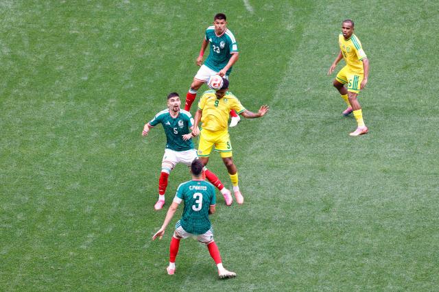 Mexico's defender #05 Johan Vasquez and South Africa's forward #09 Lyle Foster fight for the ball during the 2026 World Cup Group A football match between Mexico and South Africa at the Mexico City Stadium in Mexico City on June 11, 2026. (Photo by Rodrigo OROPEZA / AFP)