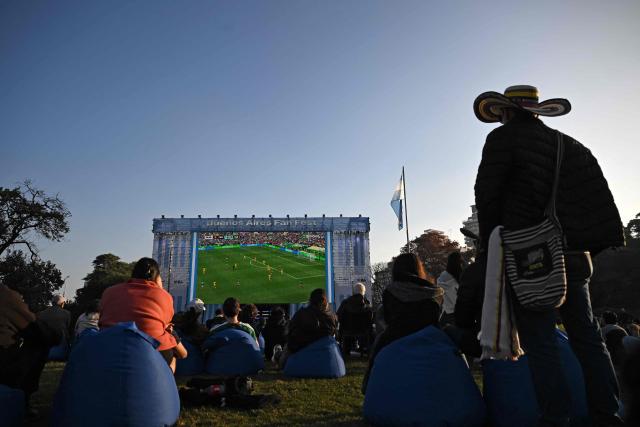 People watch the opening match of the 2026 World Cup, a Group A match between Mexico and South Africa in a giant screen in Buenos Aires on June 11, 2026. (Photo by Luis ROBAYO / AFP)