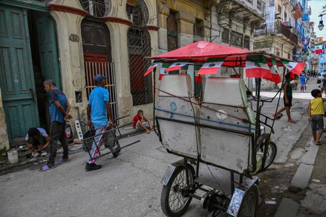 A bicycle taxi decorated with Mexico's flags is seen on a street in Havana during the World Cup opening match between Mexico and South Africa on June 11, 2026. (Photo by YAMIL LAGE / AFP)
