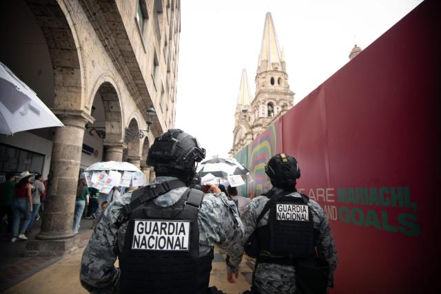 National Guard members walk along barriers surrounding the FIFA Fan Festival Guadalajara at Plaza de la Liberacion and Plaza de Armas in Guadalajara, Jalisco state, Mexico, on June 11, 2026 during the opening of the FIFA World Cup 2026. (Photo by RUTH ROSAS / AFP)