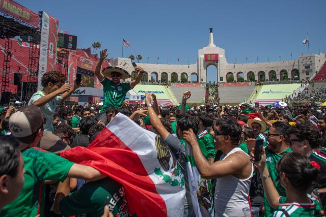 Mexico fans celebrate victory as they watch the Mexico and South Africa match on opening day of the 2026 World Cup football tournament during the FIFA Fan Festival at the LA Memorial Coliseum in Los Angeles on June 11, 2026. Mexico ignited their World Cup party with a dominant 2-0 victory over nine-man South Africa on Thursday as the biggest ever edition of the global footballing showpiece kicked off at the iconic Estadio Azteca. (Photo by Apu GOMES / AFP)
