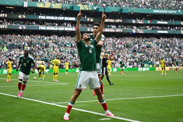 Mexico's forward #09 Raul Jimenez celebrates with teammate midfielder #19 Gilberto Mora scoring his team's second goal during the 2026 World Cup Group A football match between Mexico and South Africa at the Mexico City Stadium in Mexico City on June 11, 2026. (Photo by CARL DE SOUZA / AFP)