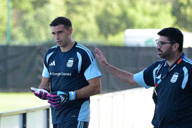 Argentina's goalkeeper Emiliano Martinez (L) and media manager Nicolas Novello arrive for in a training session during the 2026 World Cup football tournament at Sporting KC Training Centre in Kansas City on June 11, 2026. (Photo by JUAN MABROMATA / AFP)