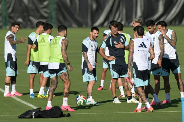 Argentina's forward Lionel Messi (C-L) and fitness coach Luis Martin (C-R) talk during a training session for the 2026 World Cup football tournament at Sporting KC Training Centre in Kansas City on June 11, 2026. (Photo by JUAN MABROMATA / AFP)
