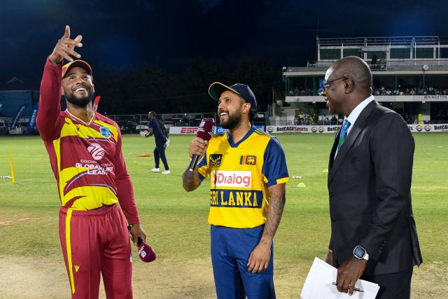 Shai Hope (L) of West Indies tosses the coin as Kusal Mendis (C) of Sri Lanka and match referee Sir Richie Richardson (R) look on during the first Twenty20 (T20) international cricket match between West Indies and Sri Lanka at Sabina Park in Kingston, Jamaica, on June 11, 2026. (Photo by Randy Brooks / AFP)