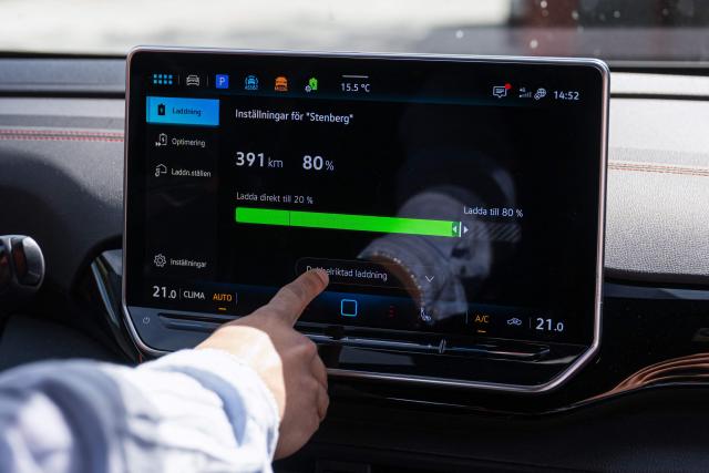 Herbert Svensson configures bi-directional charging settings inside a Volkswagen electric vehicle at the BRF Stenberg condominium association on May 28, 2026, in Hudiksvall, Sweden. The residential pilot project uses Vehicle-to-Grid (V2G) technology, enabling electric vehicles to act as mobile energy storage units capable of supplying electricity back to the local grid when needed. (Photo by Jonathan NACKSTRAND / AFP)