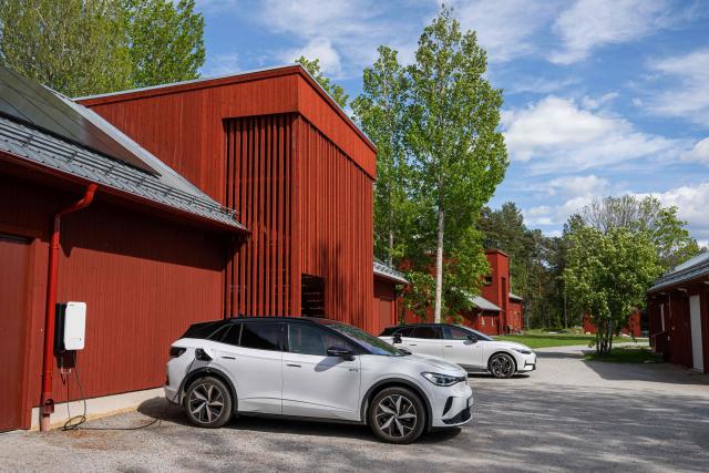 A Volkswagen electric vehicle charges at the BRF Stenberg condominium association on May 28, 2026, in Hudiksvall, Sweden. The residential pilot project uses Vehicle-to-Grid (V2G) technology, enabling electric vehicles to act as mobile energy storage units capable of supplying electricity back to the local grid when needed. (Photo by Jonathan NACKSTRAND / AFP)