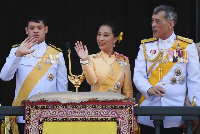 (FILES) Thailand's Prince Dipangkorn Rasmijoti (L), Princess Bajrakitiyabha Mahidol (C) and King Maha Vajiralongkorn (R) wave from the balcony of Suddhaisavarya Prasad Hall of the Grand Palace as they grant a public audience on the final day of his royal coronation in Bangkok on May 6, 2019. Thai Princess Bajrakitiyabha Mahidol, the king's eldest daughter, has died aged 47, the royal palace announced on June 12, 2026, more than three years after she was hospitalised following a sudden illness. (Photo by Jewel SAMAD / AFP)