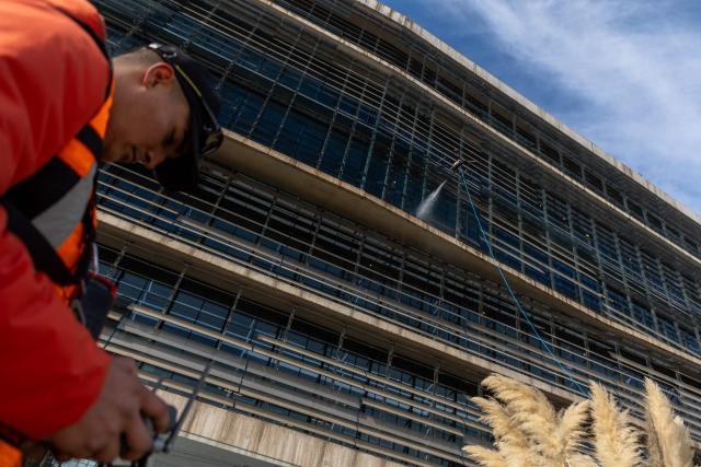 View of a drone cleaning a large building facade in Santiago, on June 11, 2026. A group of Chilean entrepreneurs created a company that uses drones to clean buildings, high-voltage towers, solar panels, and large elevated surfaces (Photo by Raul BRAVO / AFP)