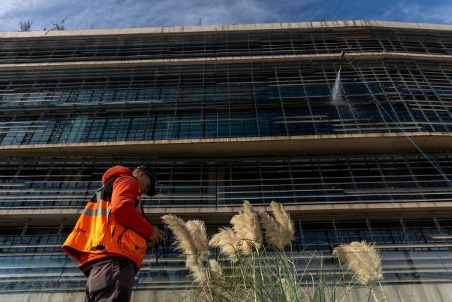 View of a drone cleaning a large building facade in Santiago, on June 11, 2026. A group of Chilean entrepreneurs created a company that uses drones to clean buildings, high-voltage towers, solar panels, and large elevated surfaces (Photo by Raul BRAVO / AFP)