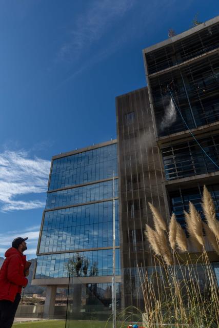 View of a drone cleaning a large building facade in Santiago, on June 11, 2026. A group of Chilean entrepreneurs created a company that uses drones to clean buildings, high-voltage towers, solar panels, and large elevated surfaces (Photo by Raul BRAVO / AFP)