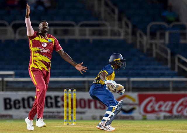 Jason Holder (L) of West Indies appeals for leg before wicket (LBW) against Lasith Croospulle (R) of Sri Lanka during the first Twenty20 (T20) international cricket match between West Indies and Sri Lanka at Sabina Park in Kingston, Jamaica, on June 11, 2026. (Photo by Randy Brooks / AFP)