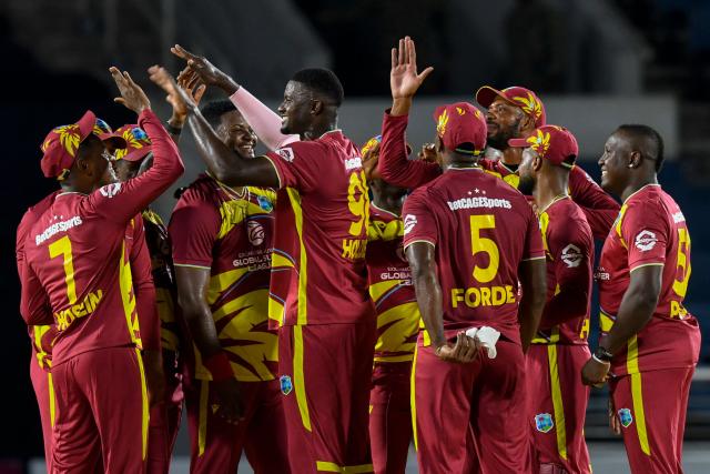 Jason Holder (2L) of West Indies celebrates the dismissal of unseen Lasith Croospulle of Sri Lanka during the first Twenty20 (T20) international cricket match between West Indies and Sri Lanka at Sabina Park in Kingston, Jamaica, on June 11, 2026. (Photo by Randy Brooks / AFP)