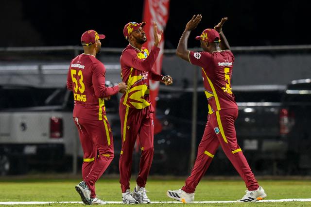 Roston Chase (C) of West Indies celebrates the dismissal of unseen Kusal Mendis of Sri Lanka during the first Twenty20 (T20) international cricket match between West Indies and Sri Lanka at Sabina Park in Kingston, Jamaica, on June 11, 2026. (Photo by Randy Brooks / AFP)