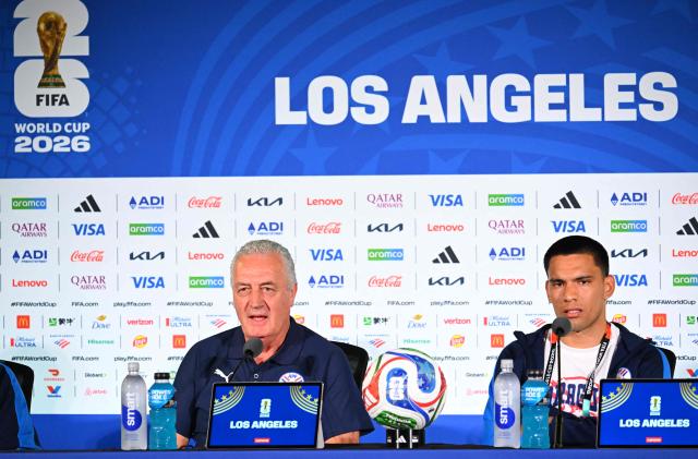 Paraguay's Argentine head coach Gustavo Alfaro (L) and midfielder Diego Gomez (R) give a press conference at Los Angeles Stadium in Inglewood on June 11, 2026, on the eve of the 2026 World Cup football match between USA and Paraguay. (Photo by Patrick T. Fallon / AFP)