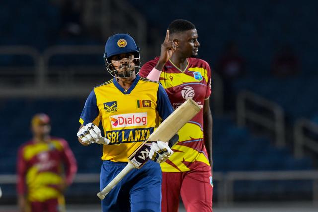 Maheesh Theekshana (L) of Sri Lanka walks off the field dismissed by Jason Holder (R) of West Indies during the first Twenty20 (T20) international cricket match between West Indies and Sri Lanka at Sabina Park in Kingston, Jamaica, on June 11, 2026. (Photo by Randy Brooks / AFP)