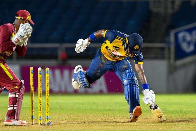 Kamindu Mendis (R) of Sri Lanka is run out by Shai Hope (L) of West Indies during the first Twenty20 (T20) international cricket match between West Indies and Sri Lanka at Sabina Park in Kingston, Jamaica, on June 11, 2026. (Photo by Randy Brooks / AFP)
