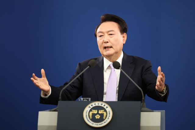 (FILES) South Korean President Yoon Suk Yeol answers a reporter's question during a press conference at the Presidential Office in Seoul on November 7, 2024. South Korea's ex-president Yoon Suk Yeol was sentenced to 30 years in prison on June 12, 2026 for sending drones into North Korea, a move prosecutors argued was aimed at creating a pretext for his disastrous December 2024 declaration of martial law. (Photo by KIM HONG-JI / POOL / AFP)