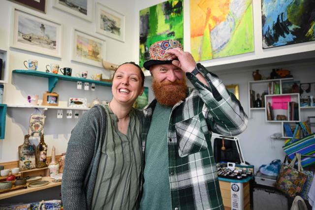 Jeweler Roxana Saraev (L) and her husband Claudiu (R) are pictured in their shop in Sulina city, May 09, 2026. In Sulina, Romania’s easternmost point, Roxana Saraev has decided that anxiety about Russian airstrikes in Ukraine, some kilometres away, won’t make her leave the "oasis of tranquility" she moved to five years ago.In four years of war, the EU and NATO country which shares a 650 km border with Ukraine, has recorded 28 airspace breaches and 47 drone crashes, according to the latest data of the defence ministry. The most serious such incident happened on May 29 in the centre of the city of Galati, 150 km north of Sulina. (Photo by Daniel MIHAILESCU / AFP)