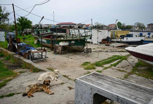 Fishermens boat and skiffs are pictured in Sulina city, Roamia, on May 09, 2026. Many Romanians living near the border feel unprotected as dozens of airspace breaches were confirmed. They receive phone alerts about possible drone danger, usually during the night. In four years of war, as Russia bombed Ukrainian ports, Romanians living near the border got used to the sound of drones approaching, sometimes even crashing on national soil. NATO and the European Union are working on a possible "drone wall", with Romania, which shares a 650-km border with Ukraine, asking for capabilities from the middle of the continent to be moved on the eastern flank. (Photo by Daniel MIHAILESCU / AFP)