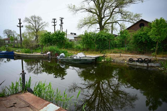 Fishermens boat and skiffs are pictured in Sulina city, Roamia, on May 09, 2026. Many Romanians living near the border feel unprotected as dozens of airspace breaches were confirmed. They receive phone alerts about possible drone danger, usually during the night. In four years of war, as Russia bombed Ukrainian ports, Romanians living near the border got used to the sound of drones approaching, sometimes even crashing on national soil. NATO and the European Union are working on a possible "drone wall", with Romania, which shares a 650-km border with Ukraine, asking for capabilities from the middle of the continent to be moved on the eastern flank. (Photo by Daniel MIHAILESCU / AFP)