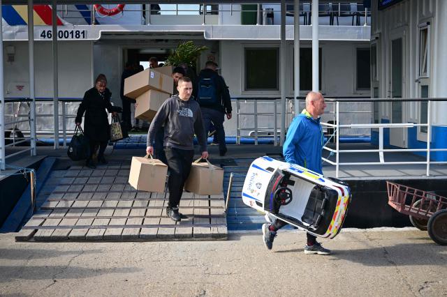 Passengers disembark from the ship coming from Tulcea in Sulina city, Romaia, on May 08, 2026. Many Romanians living near the border feel unprotected as dozens of airspace breaches were confirmed. They receive phone alerts about possible drone danger, usually during the night. In four years of war, as Russia bombed Ukrainian ports, Romanians living near the border got used to the sound of drones approaching, sometimes even crashing on national soil. NATO and the European Union are working on a possible "drone wall", with Romania, which shares a 650-km border with Ukraine, asking for capabilities from the middle of the continent to be moved on the eastern flank. (Photo by Daniel MIHAILESCU / AFP)