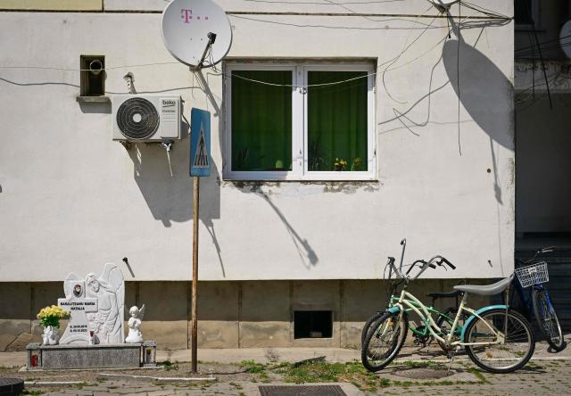 This picture shows a memorial monument for a child who died in an accident next to a block of flats in Sulina city, Romania, on May 08, 2026. Many Romanians living near the border feel unprotected as dozens of airspace breaches were confirmed. They receive phone alerts about possible drone danger, usually during the night. In four years of war, as Russia bombed Ukrainian ports, Romanians living near the border got used to the sound of drones approaching, sometimes even crashing on national soil. NATO and the European Union are working on a possible "drone wall", with Romania, which shares a 650-km border with Ukraine, asking for capabilities from the middle of the continent to be moved on the eastern flank. (Photo by Daniel MIHAILESCU / AFP)