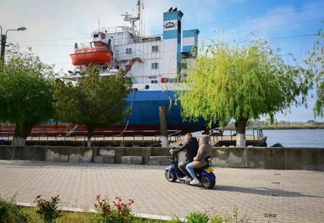 A moored commercial vessel is pictured in Sulina city, Romania, on May 08, 2026. Many Romanians living near the border feel unprotected as dozens of airspace breaches were confirmed. They receive phone alerts about possible drone danger, usually during the night. In four years of war, as Russia bombed Ukrainian ports, Romanians living near the border got used to the sound of drones approaching, sometimes even crashing on national soil. NATO and the European Union are working on a possible "drone wall", with Romania, which shares a 650-km border with Ukraine, asking for capabilities from the middle of the continent to be moved on the eastern flank. (Photo by Daniel MIHAILESCU / AFP)