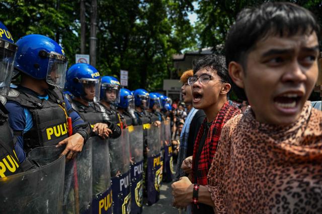 People face a line of police as they protest in Manila on June 12, 2026, to coincide with the country’s Independence Day celebrations. (Photo by Jam STA ROSA / AFP)