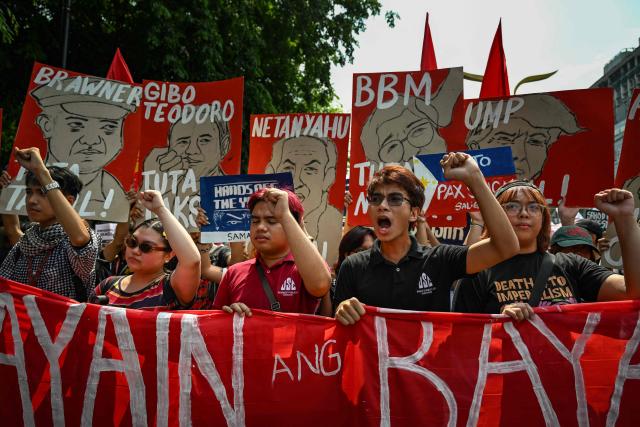 People raise their fist as they protest in Manila on June 12, 2026, to coincide with the country’s Independence Day celebrations. (Photo by Jam STA ROSA / AFP)