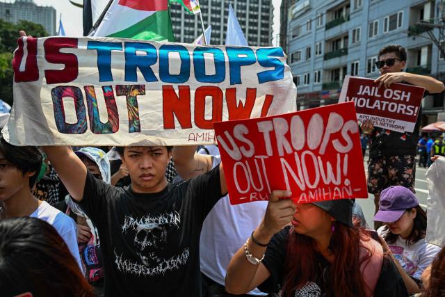 People raise banners as they protest in Manila on June 12, 2026, to coincide with the country’s Independence Day celebrations. (Photo by Jam STA ROSA / AFP)
