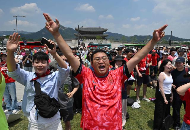 South Korean fans cheer after their team scored a goal as they watch the 2026 World Cup football match between South Korea and the Czech Republic on big screens in Seoul on June 12, 2026. (Photo by Jung Yeon-je / AFP)